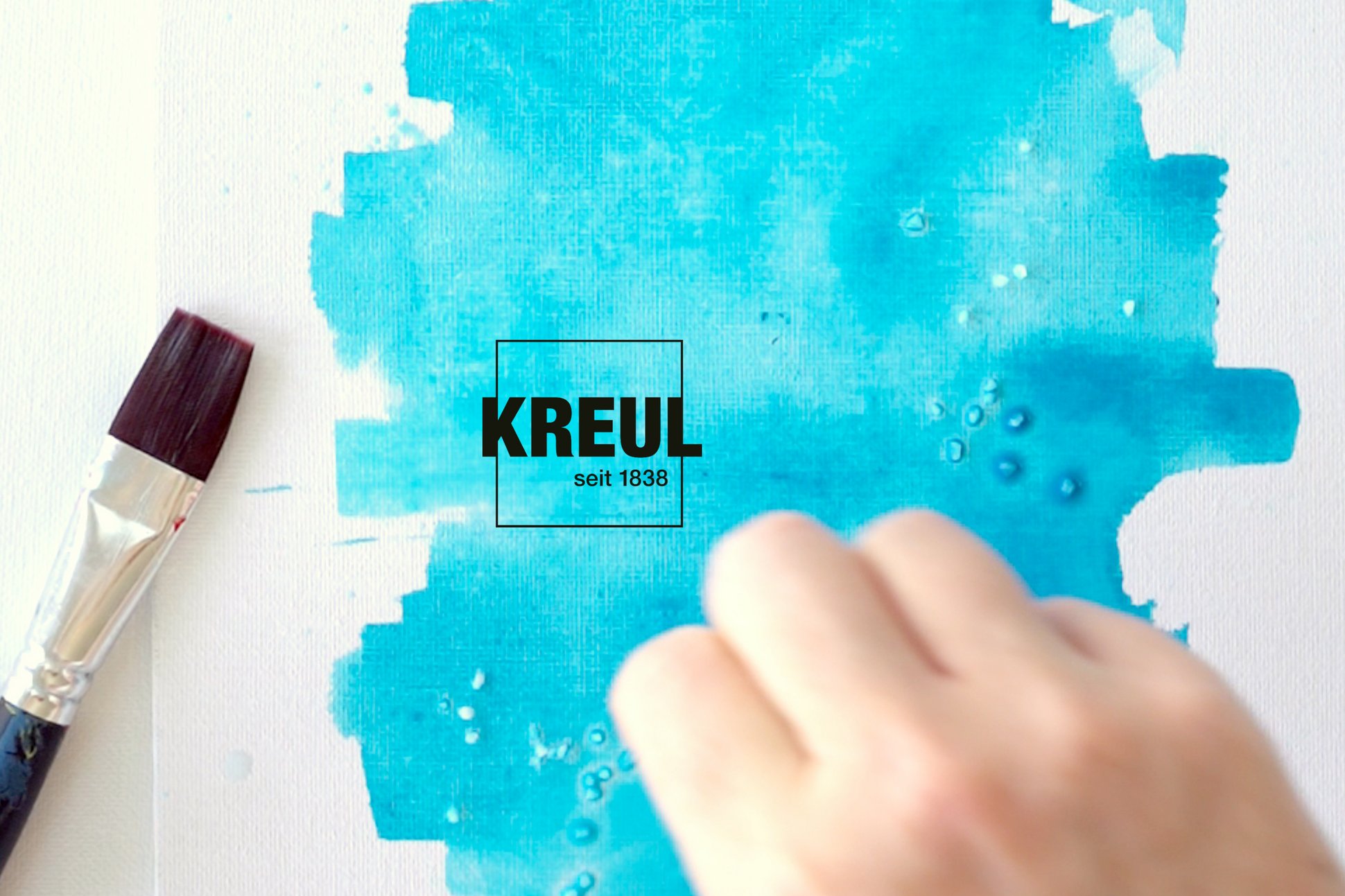 KREUL Seidenmalfarbe Malen Papier Kunst Lettering Effekt mit Salz und Spritzern Pinsel Hand streut Salz auf nasse Fläche mit türkiser KREUL Seidenmalfarbe